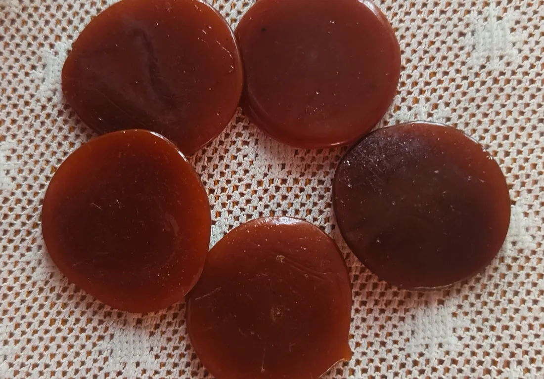 Handmade button lac discs, deep amber to reddish brown